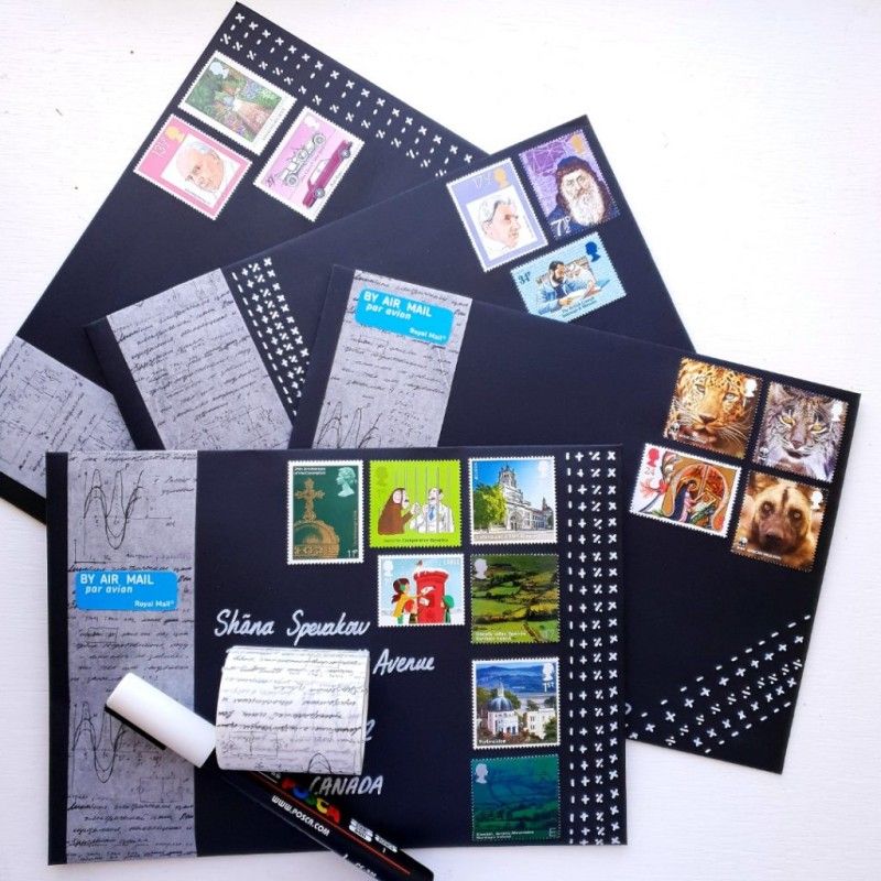 Colourful postage stamps on black envelopes