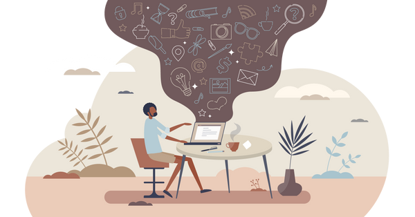 Man sitting at a desk on a laptop computer with ideas spilling out of the laptop.