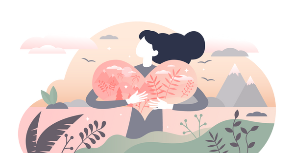 Girl hugging a heart filled with the natural world.